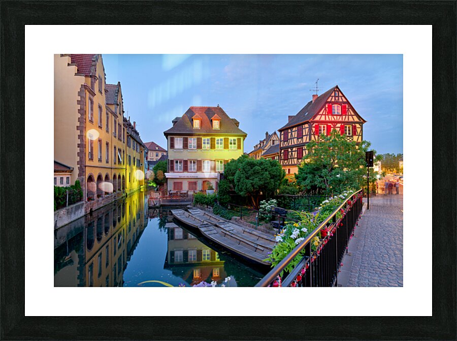 Timber framed houses and visitors in Colmar canals at dusk Picture Frame print