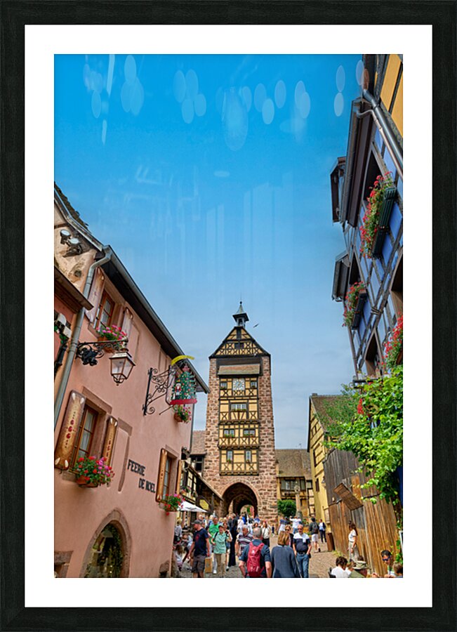 Tourists stroll through historic streets in Riquewihr Alsace Picture Frame print