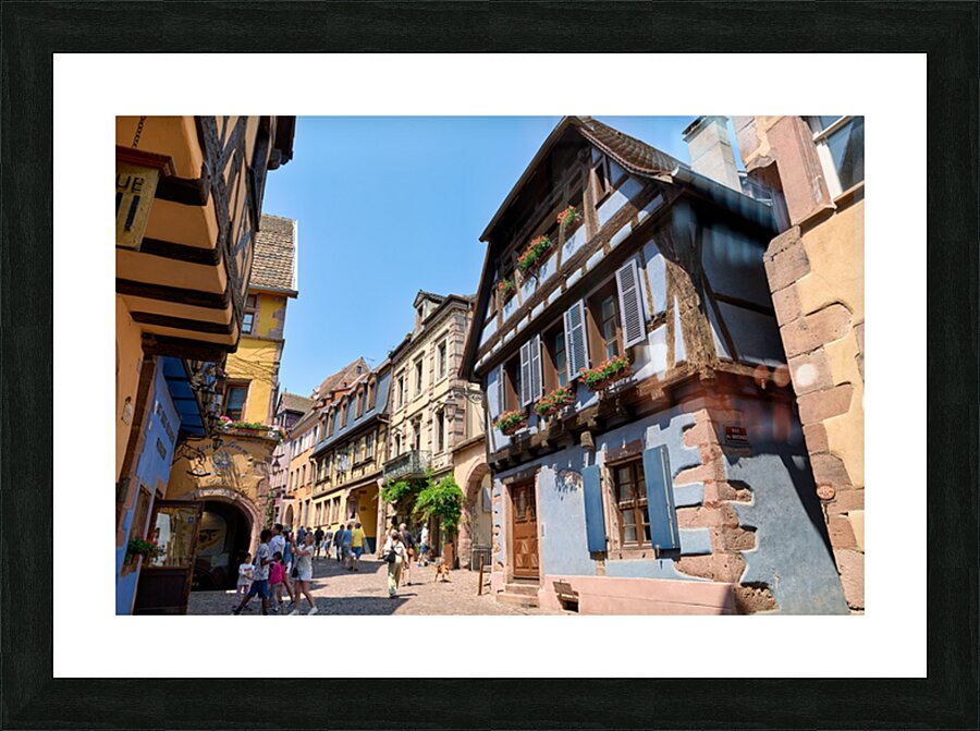 Visitors discover timber houses in Riquewihr Alsace Picture Frame print