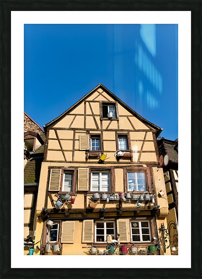 Timber framed houses in Colmar with clear blue sky above Picture Frame print