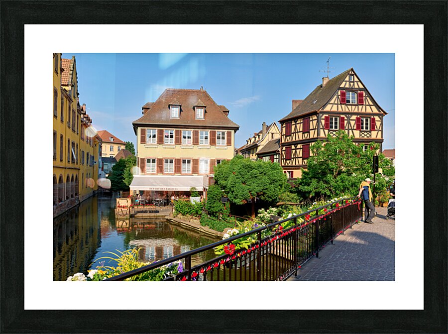 Visitors stroll by timber framed houses along the canal in Colma Picture Frame print