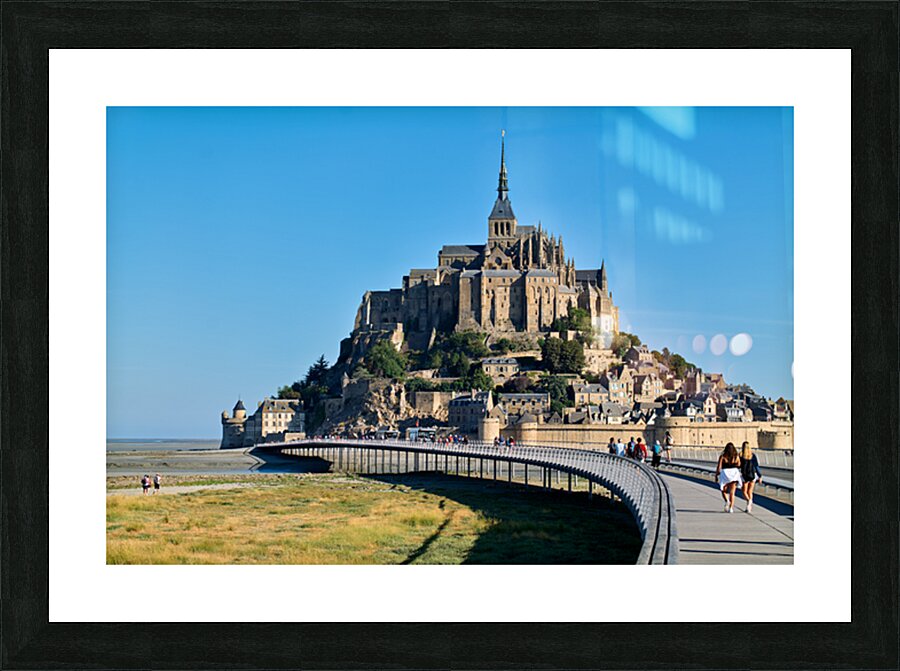 Tourists walking along the path to Mont Saint Michel in Normandy Picture Frame print
