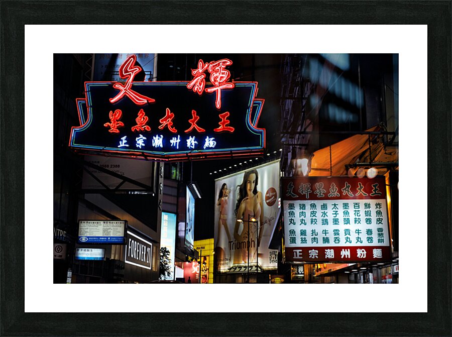 Neon signs light up a busy street in Hong Kong at night Picture Frame print