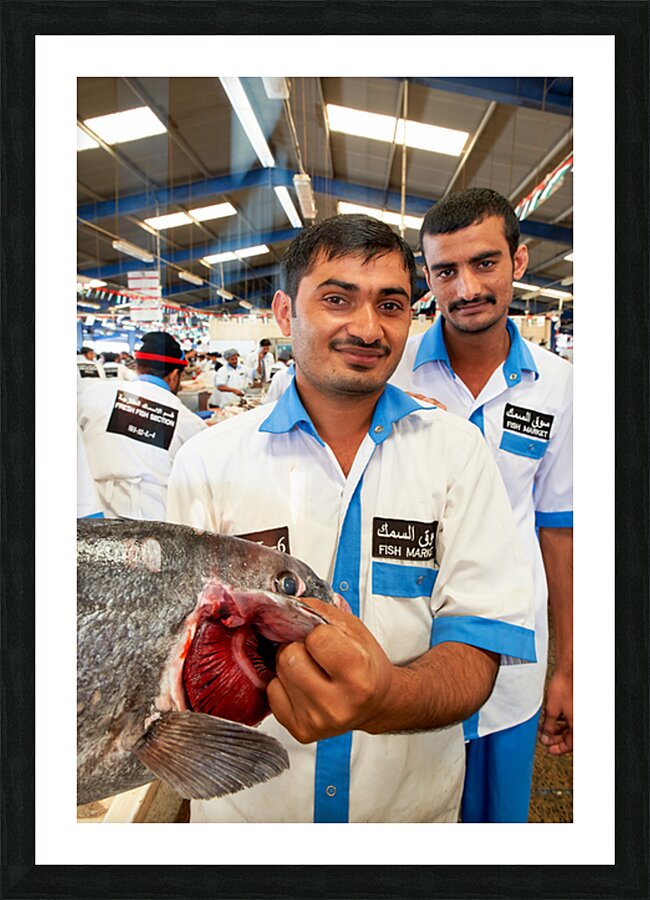 Smiling fishmongers hold fresh fish at market in Dubai UAE Picture Frame print