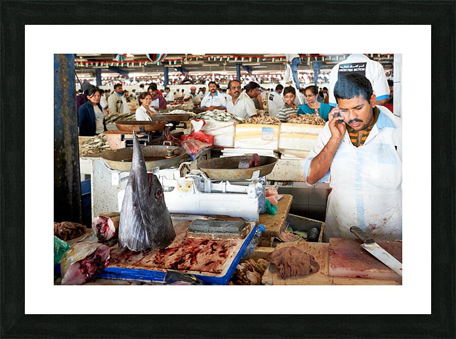 Man talks on phone at busy fish market in Dubai UAE Picture Frame print
