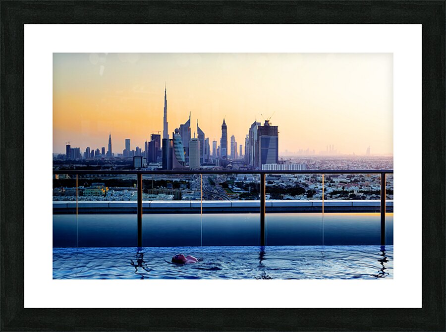 Swimming in infinity pool overlooking Dubai skyline at sunset Picture Frame print