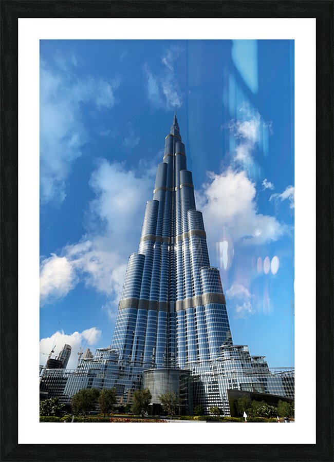 Burj Khalifa stands tall against a blue sky in Dubai UAE Picture Frame print