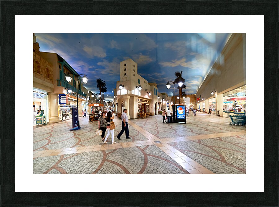 Shoppers stroll through a mall mimicking Dubais outdoor streets Picture Frame print