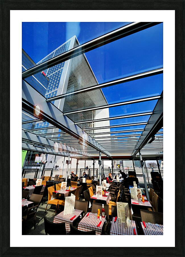 Dining area in Paris with modern building under clear sky Picture Frame print