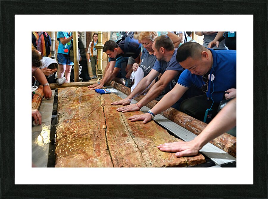 Visitors touch the stone of unction in the Holy Sepulchre Picture Frame print