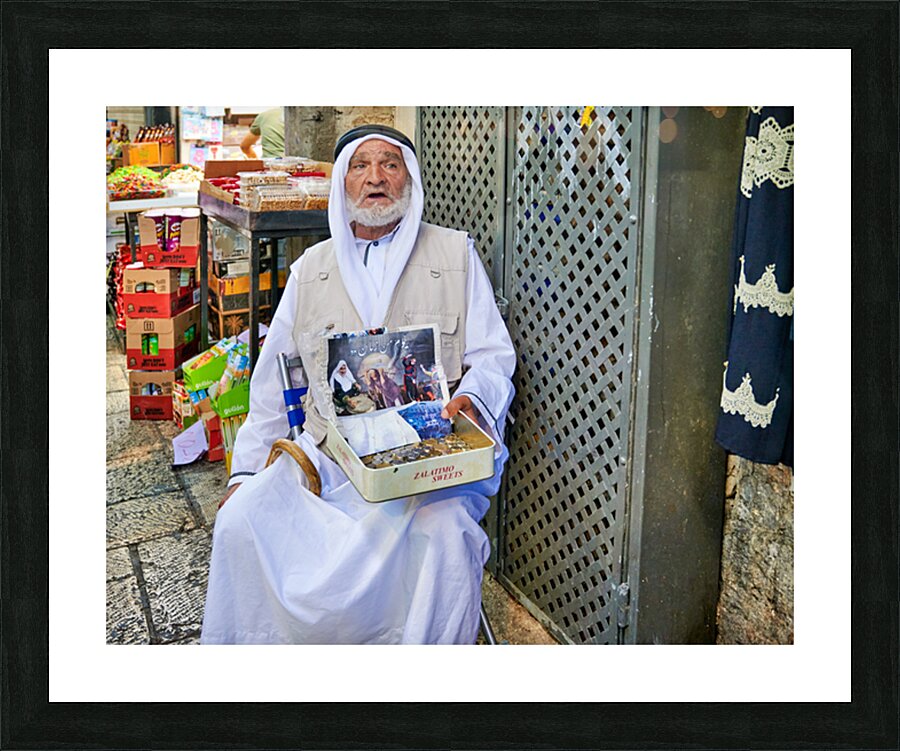 Beggar in the old city of Jerusalem seeks help from passersby Picture Frame print