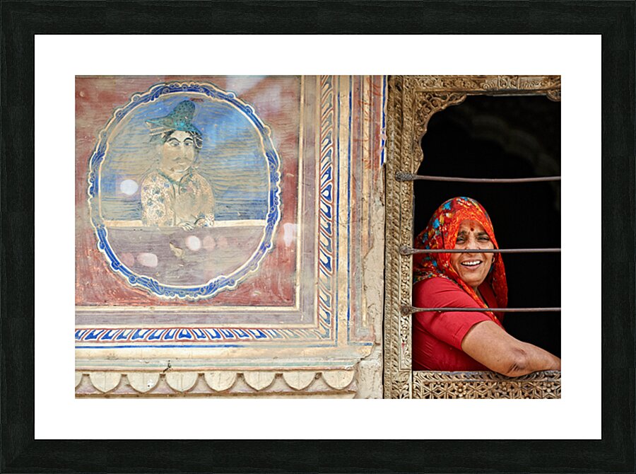 Woman smiles while looking out of a window in Mandawa Rajasthan Picture Frame print