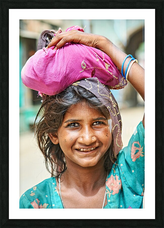Portrait of a young girl carrying cloth in Mandawa Rajasthan Picture Frame print