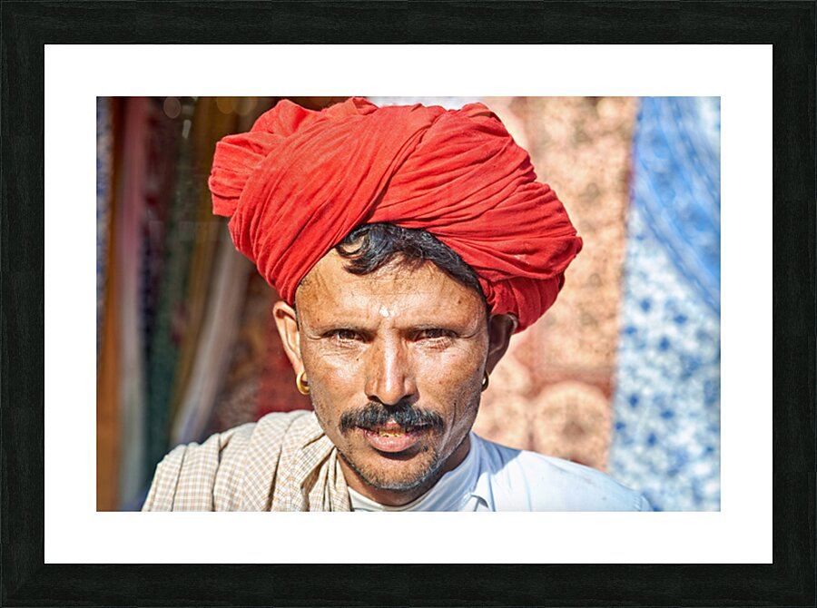 Man in red turban poses in Rajasthans Jaisalmer market street Picture Frame print