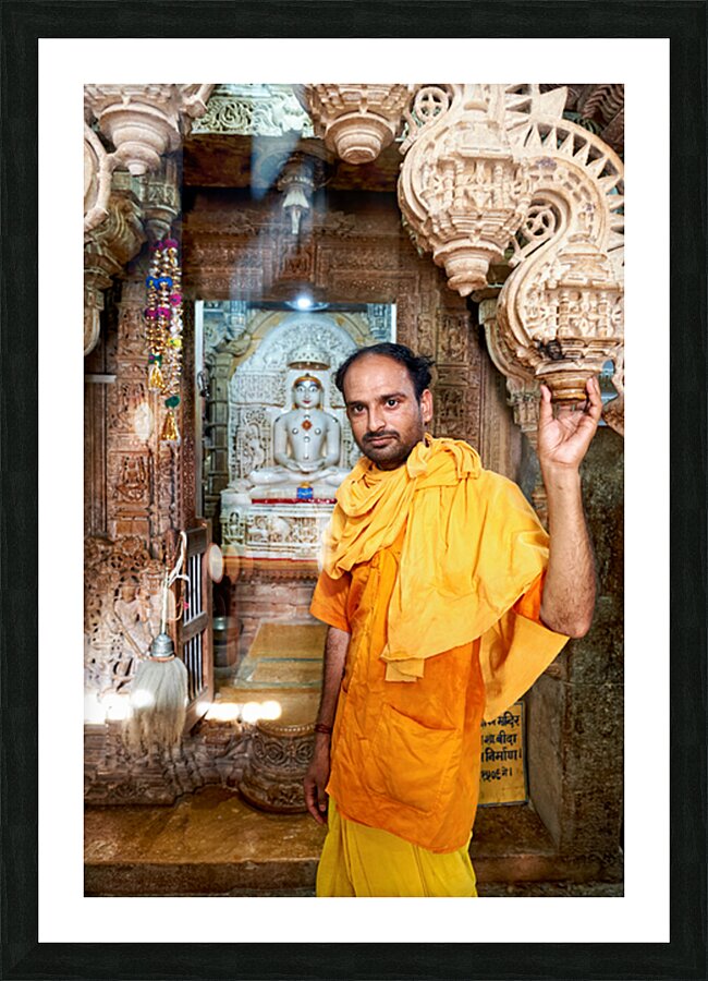 Hindu monk stands near statue in Jaisalmer Jain temple Picture Frame print