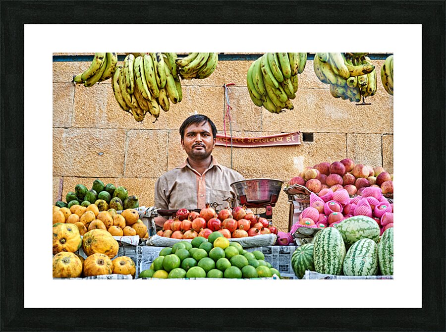 Fruits and vegetables stall in Jaisalmer with vendor at work Picture Frame print