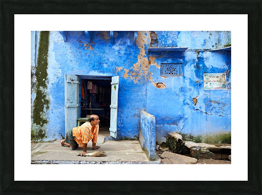 Man sweeps in front of home in Bundi Rajasthan during the day Picture Frame print