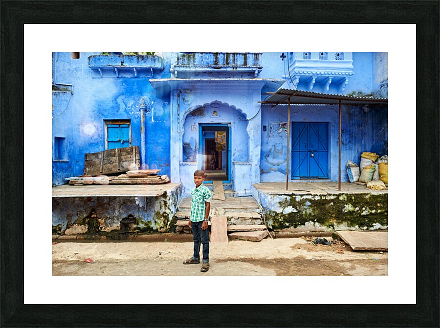 Decorated painted house in Bundi with a boy standing outside Picture Frame print