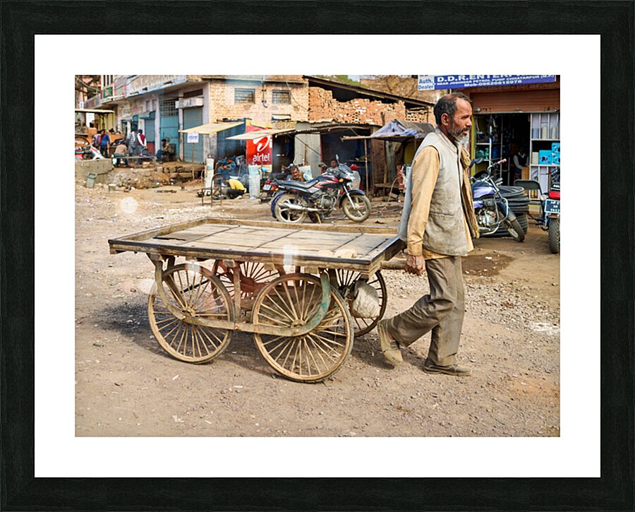 Man pulls an empty cart in Orchha Madhya Pradesh India Picture Frame print
