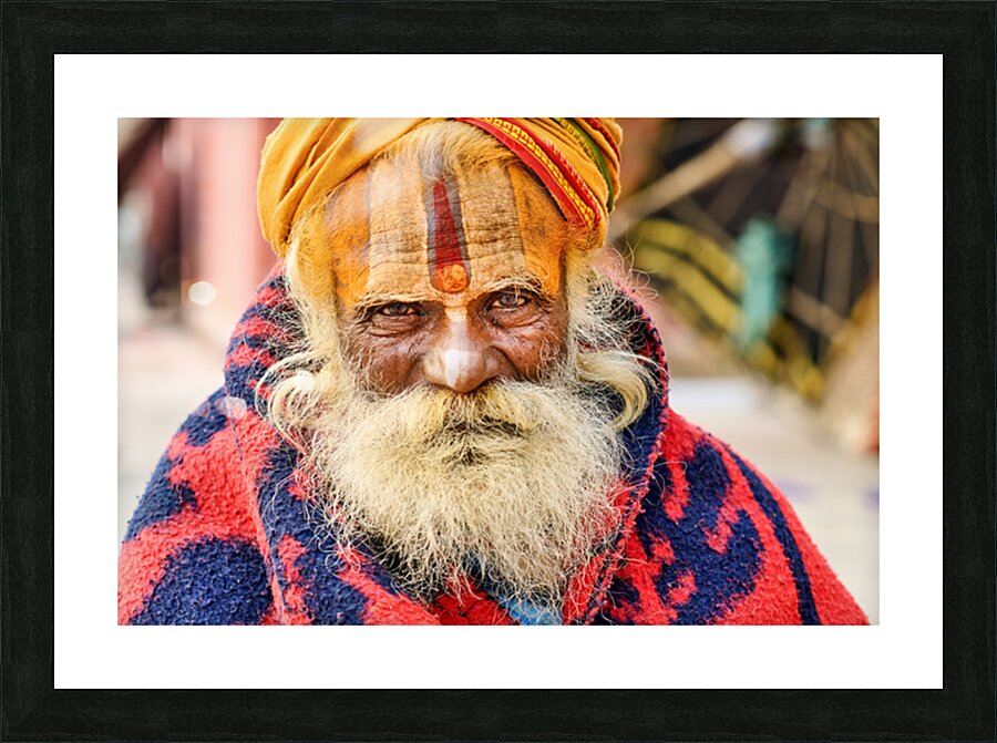 Old holy man in Varanasi wearing bright colors in Uttar Pradesh Picture Frame print