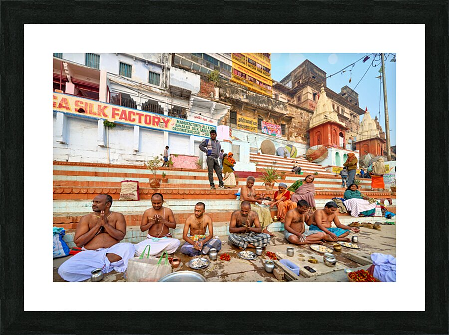 Barechested men offer prayers by the Ganges River in Varanasi Picture Frame print