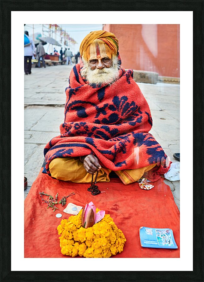 Holy man sadhu sits with offerings in Varanasi Uttar Pradesh Picture Frame print