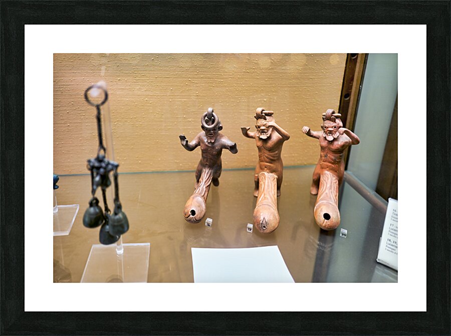 Displays of ancient artifacts are shown in glass cases Picture Frame print