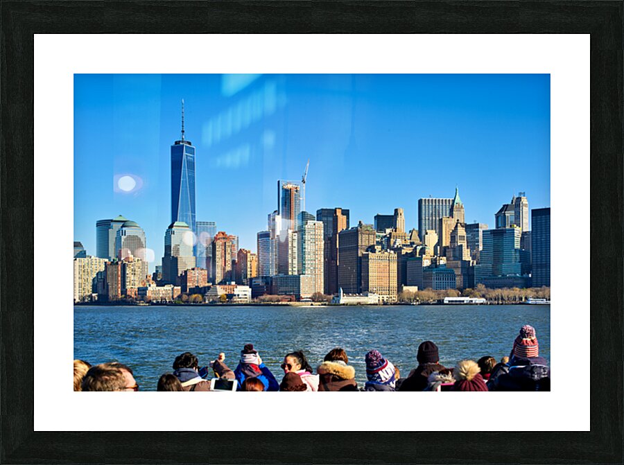 Tourists view Manhattan skyline from a boat on the water in New  Picture Frame print