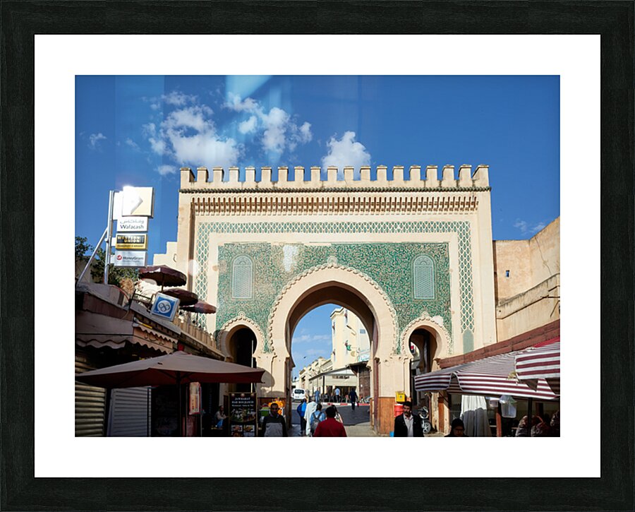 People walk through Bab Bou Jeloud a famous gate in Fez Morocc Picture Frame print