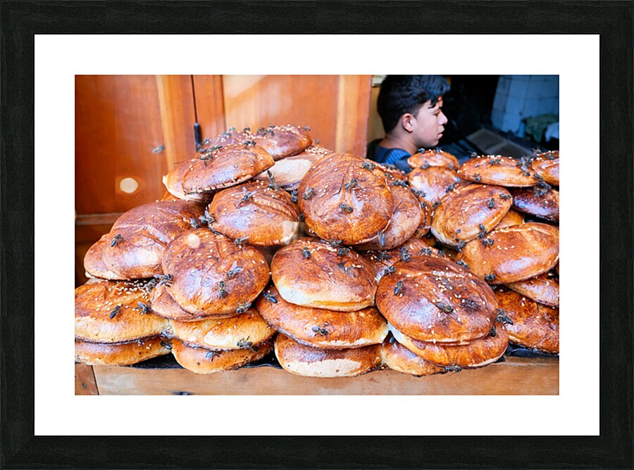 Loaf of bread covered in flies at market in Fez Morocco Picture Frame print