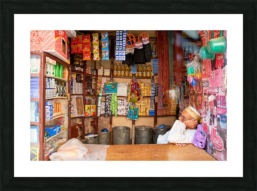 Grocer sleeping in shop in Marrakesh during afternoon hours Picture Frame print