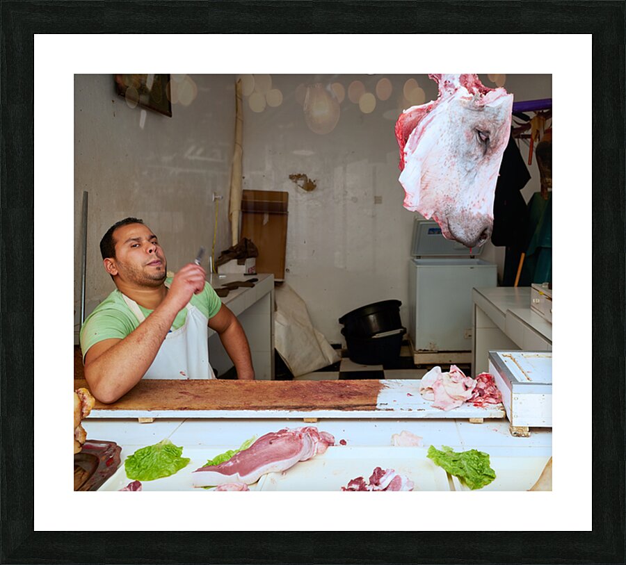Butcher at work in Meknes souk showing fresh meat and livestock Picture Frame print