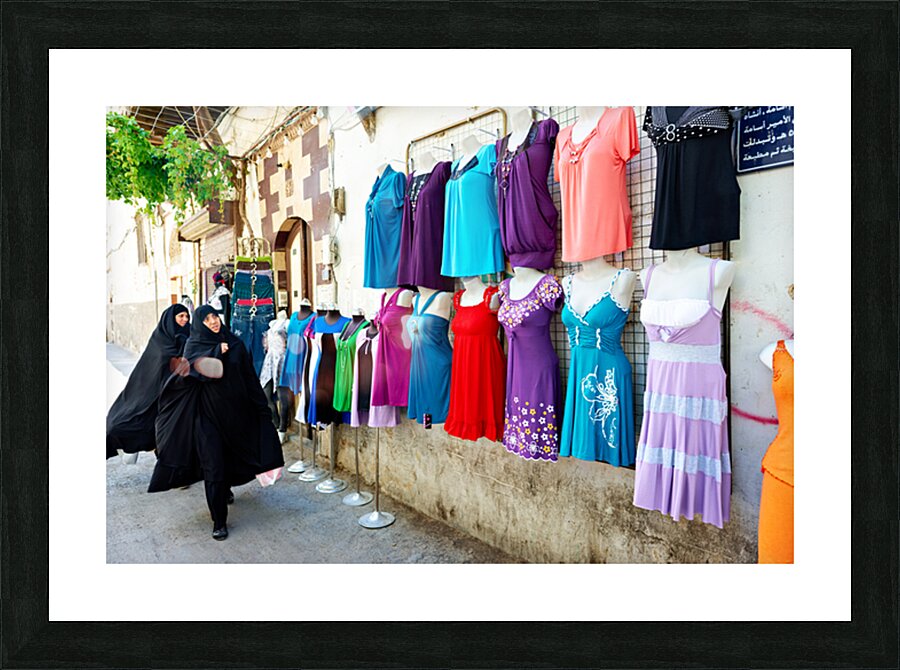 Women walk past colorful clothing displays in Damascus Syria Picture Frame print