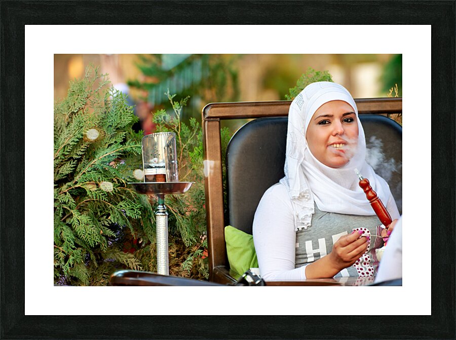 Young woman smokes hookah in outdoor cafe in Aleppo Syria Picture Frame print
