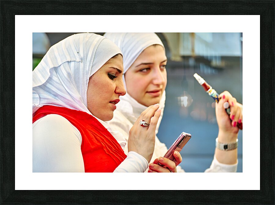 Young women enjoy hookah and talk on mobile phone in Aleppo Syri Picture Frame print