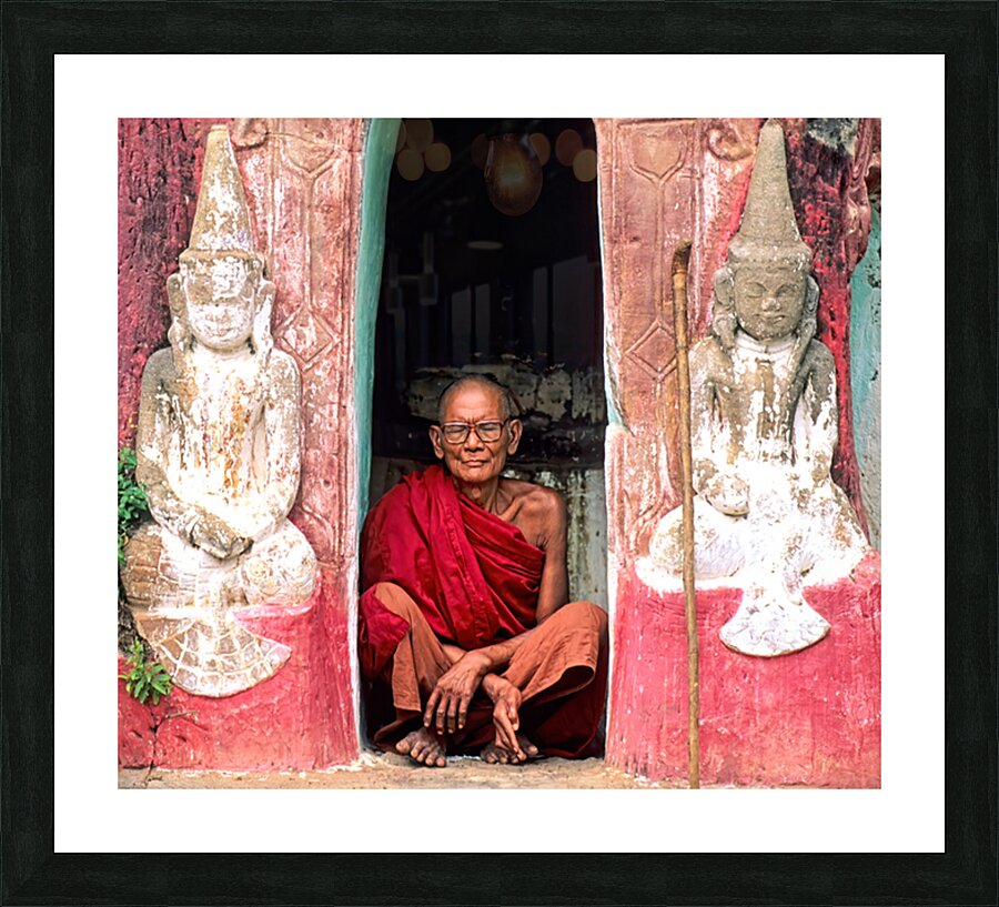 Old monk meditates in temple doorway in Myanmar Picture Frame print