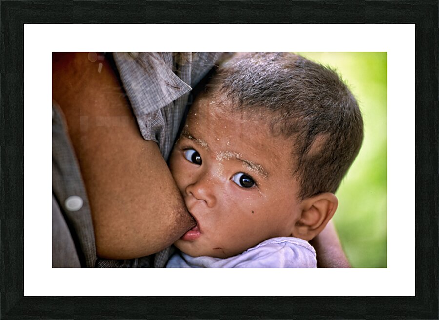 Feeding a baby in Myanmar during daytime hours Picture Frame print