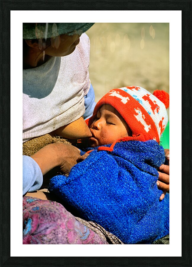 Indigenous mother nourishes child in the Andes of Argentina Picture Frame print