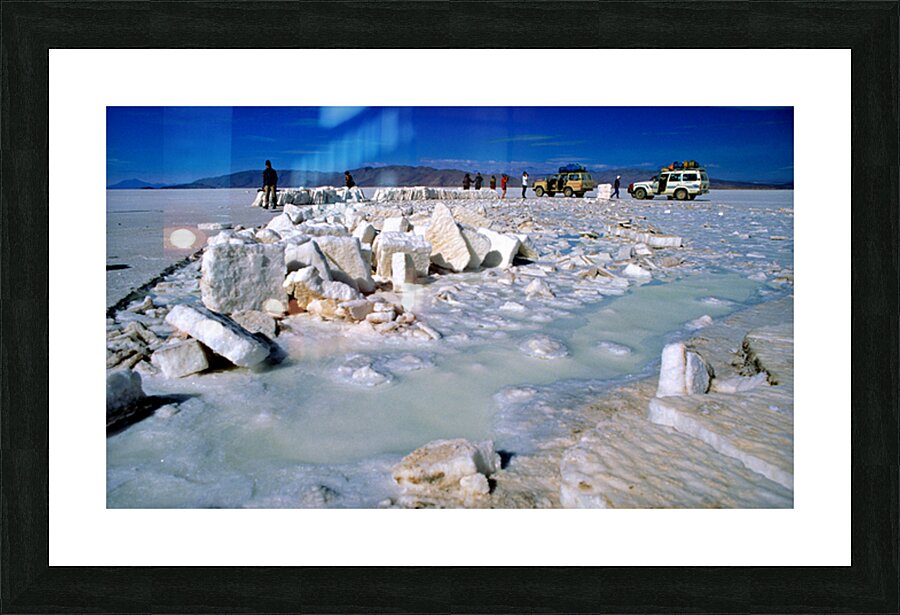 Explorers on a salt flat with salt blocks and water. Picture Frame print