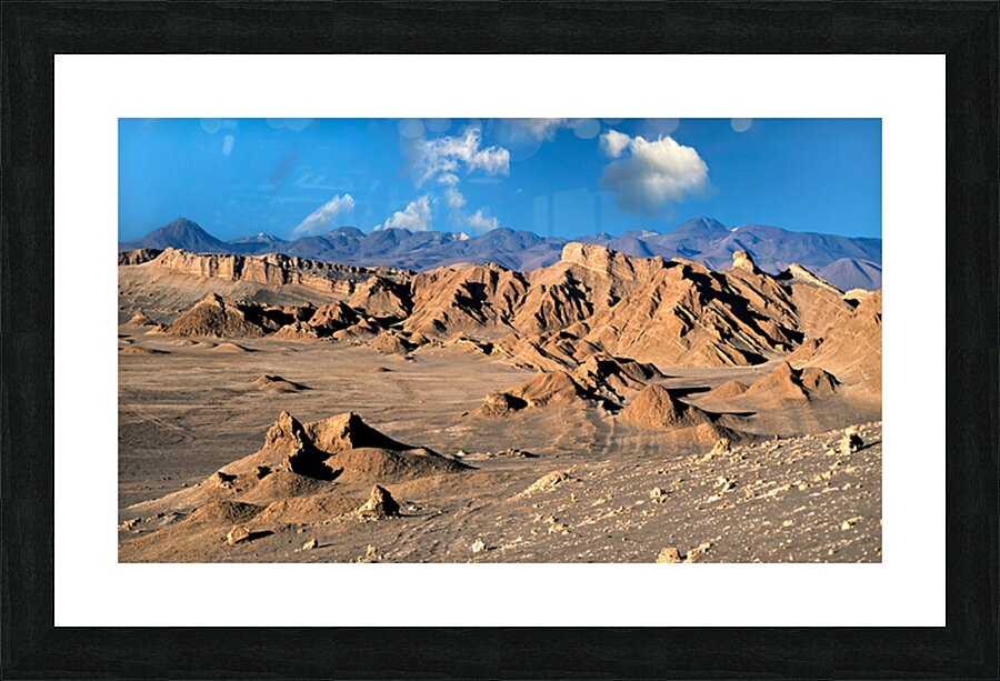 Rugged desert mountains under a clear blue sky with clouds. Picture Frame print
