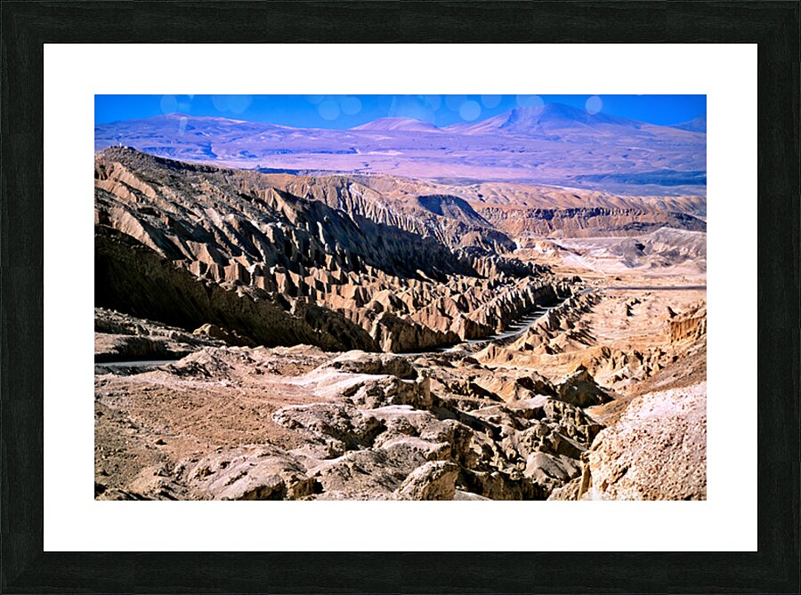 Eroded desert landscape with a road winding through mountains. Picture Frame print