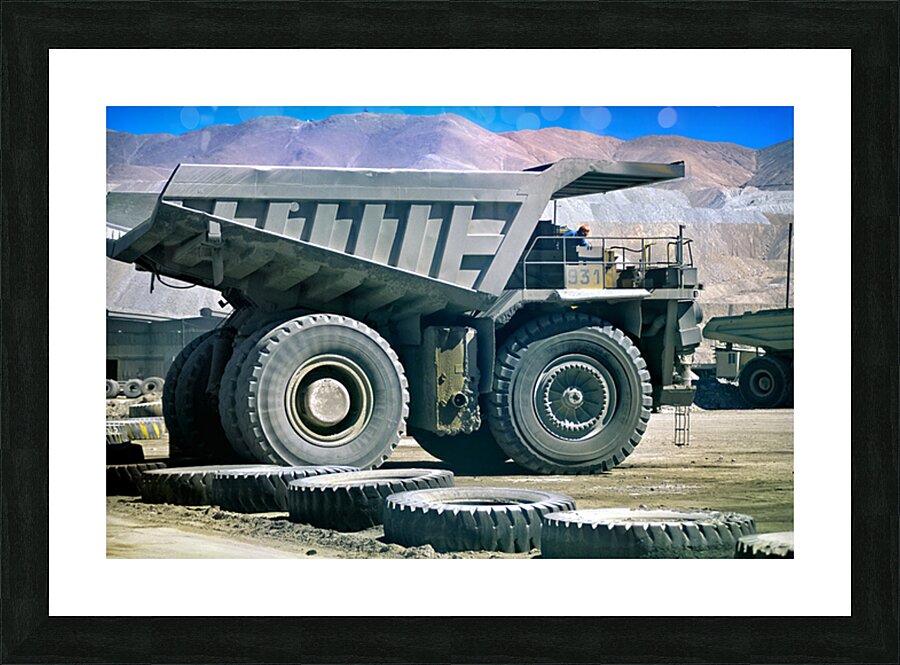 Giant mining dump truck in a dusty mountain quarry. Picture Frame print