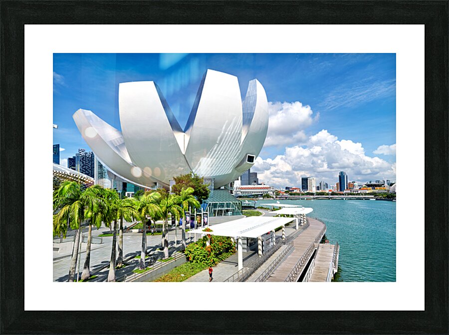 Visitors enjoy view of ArtScience Museum in Singapore near water Picture Frame print