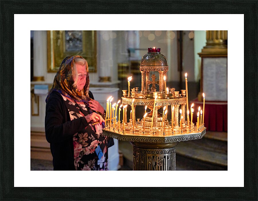 Woman lights candles at Alexander Nevsky Lavra Picture Frame print