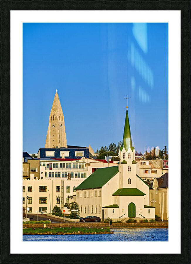 Lutheran free church by lake Tjornin and Halgrimskirkja Picture Frame print