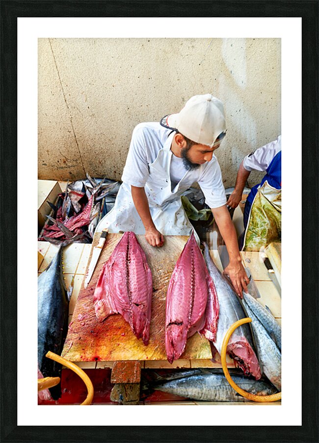Fish market in Muscat Oman shows a vendor at work Picture Frame print