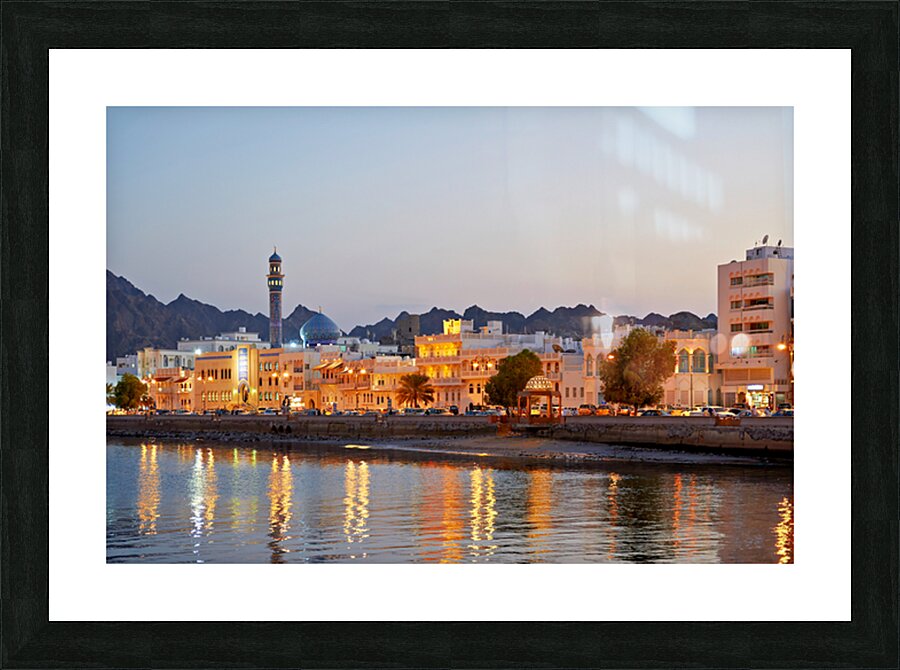 Sunset view of waterfront in Muscat Oman with city lights Picture Frame print