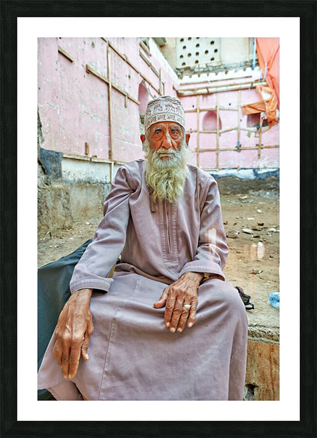 Old man sitting in a historical site in Muscat Oman Picture Frame print