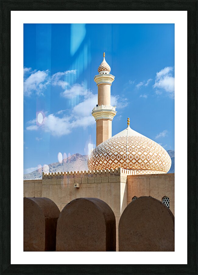 Nizwa Fort shows mosque and tower with blue sky and clouds Picture Frame print