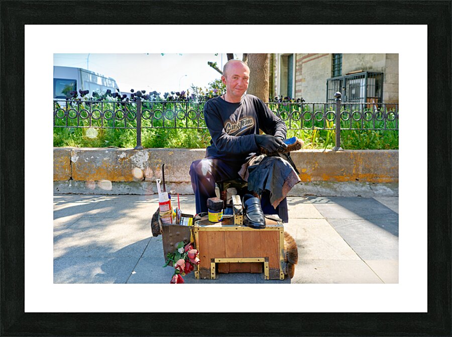Shoeblack working on shoes in Istanbul Turkey during the day Picture Frame print